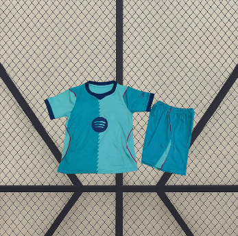 Equipación Barcelona 26-27 tercera para niño vista frontal con camiseta verde agua y turquesa y pantalón corto a juego