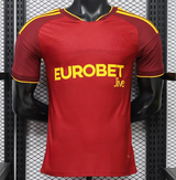 Camiseta Roma 26-27 local Player vista frontal en rojo con mangas oscuras, detalles amarillos y tejido técnico texturizado