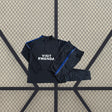 Chándal Atlético de Madrid 26-27 Modelo 2 con sudadera oscura de media cremallera y pantalón largo con detalles azules y blancos