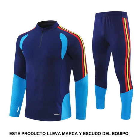 Chándal España 26-27 Modelo 2 de media cremallera con chaqueta y pantalón azul marino con detalles celestes, rojos y amarillos