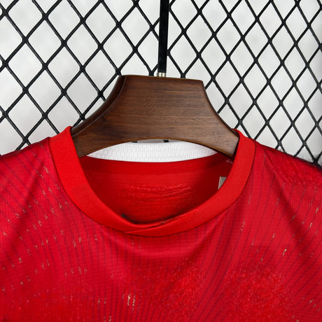 Detalle del cuello redondo rojo de la camiseta Suiza 26-27 Local de niño