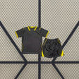 Equipación Chelsea 26-27 Visitante de niño con camiseta y pantalón oscuros y detalles amarillos en cuello, mangas y laterales