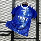 Vista frontal de la Camiseta Como 25-26 local azul con cuello blanco y estampado abstracto en el frontal
