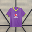 Vista frontal de la camiseta Borussia Dortmund 26-27 tercera equipación morada con cuello de pico amarillo neón y franjas verticales tonales