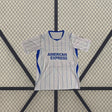 Vista frontal de la camiseta Brighton 26-27 Visitante blanca con finas líneas verticales azules, cuello redondo y paneles laterales azules