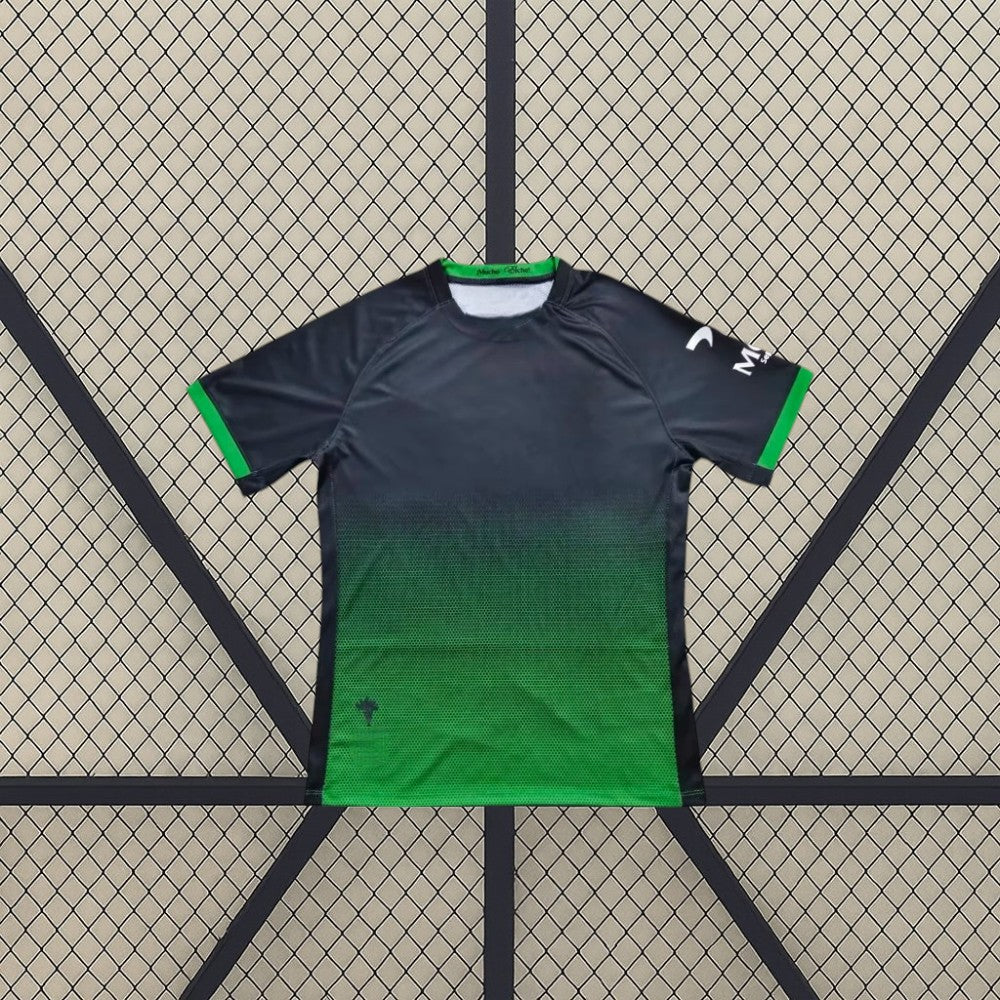 Vista frontal de la camiseta Elche 26-27 3ª equipación en azul marino y verde con efecto degradado y remates verdes en las mangas