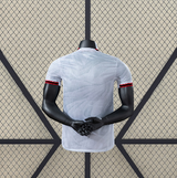 Vista trasera de la camiseta AC Milan 26-27 visitante versión Player en blanco hielo, con patrón tonal, corte ceñido y puños en contraste