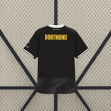 Vista trasera de la camiseta Borussia Dortmund 26-27 visitante negra con patrón tonal en la zona inferior y detalles blancos en las mangas