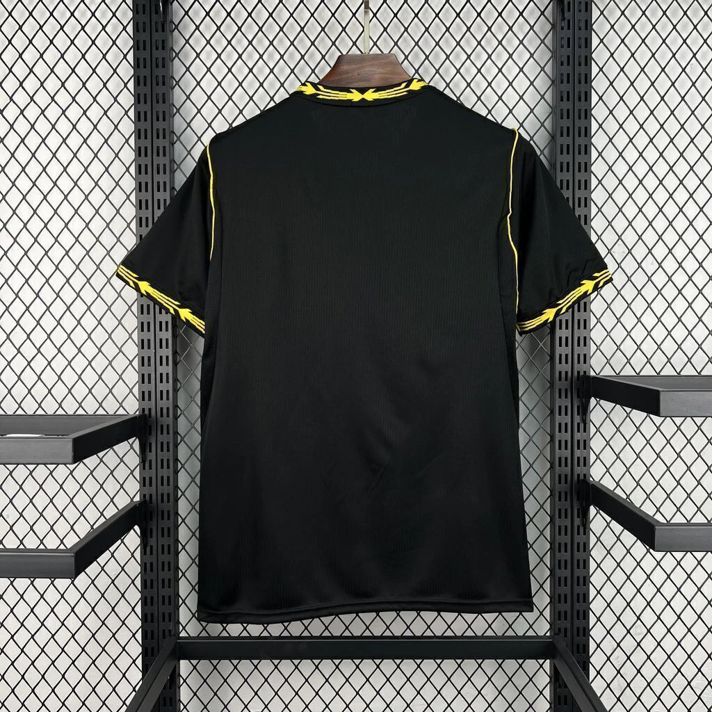 Vista trasera de la camiseta Chelsea 26-27 visitante, con espalda negra lisa y acabados amarillos en cuello y puños