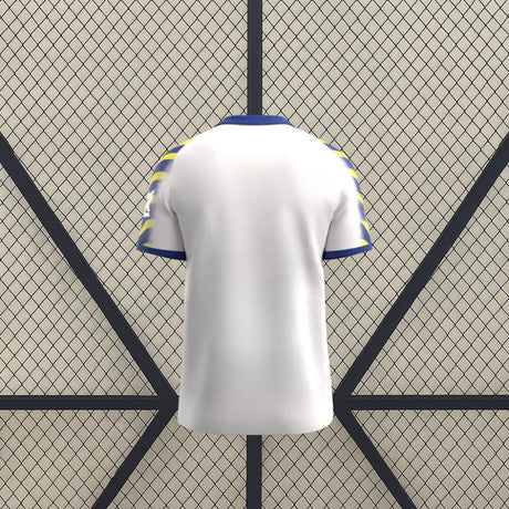 Vista trasera de la camiseta Parma 25-26 tercera equipación en color blanco, con cuello azul y mangas estampadas en azul y amarillo