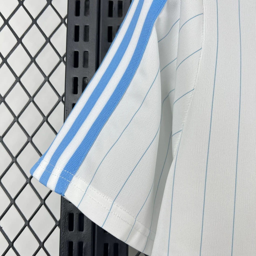 Detalle de manga de la camiseta Argentina 26-27 casual con franjas celestes y tejido blanco