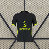 Camiseta Atlético de Madrid 26-27 visitante vista frontal en negro con detalles amarillo flúor