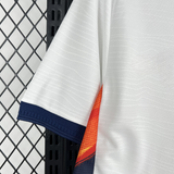 Detalle de manga blanca con puño azul marino y panel lateral naranja de la camiseta Ecuador 26-27