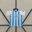 Camiseta Málaga 26-27 local frontal con franjas verticales azul celeste y blanco