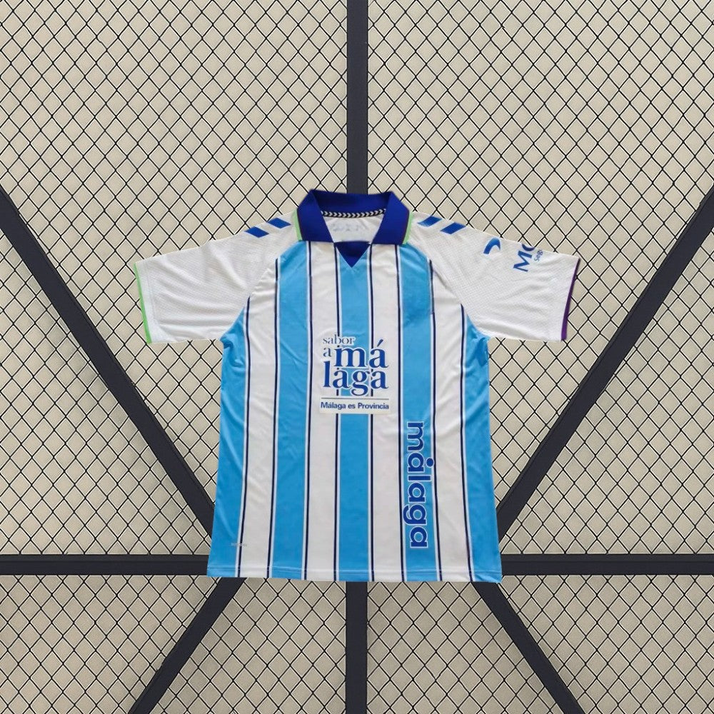 Camiseta Málaga 26-27 local frontal con franjas verticales azul celeste y blanco